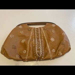 The limited tan embroidered clutch